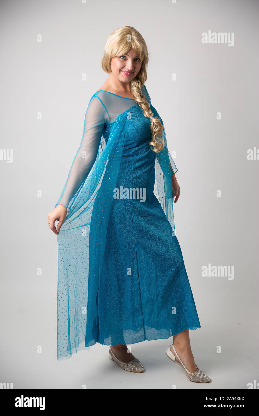 Israel, Tel Aviv October 14, 2019: Elsa from Frozen, Beautiful and Nice Lady Blonde Hair in Snow Blue Evening Gown on white background Stock Photo