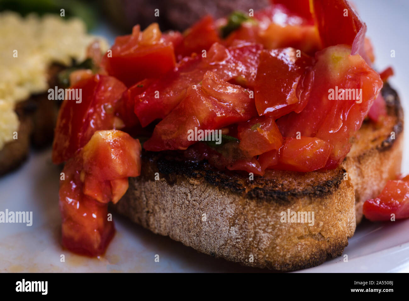 Tomato bruschettas, close up. Italian cuisine. Stock Photo