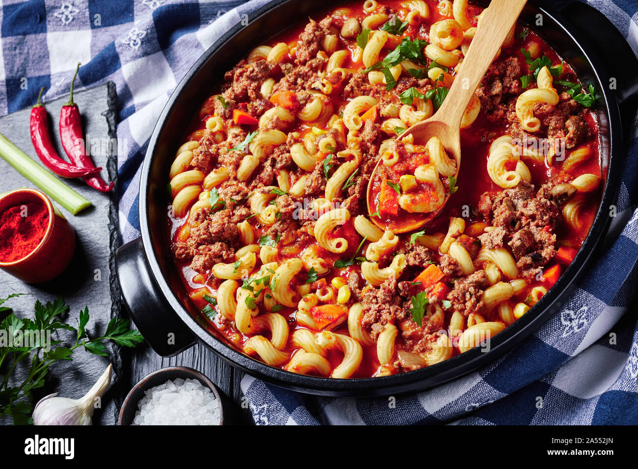 Close Up Of American Italian Goulash Of Elbow Macaroni Beef Celery And Tomatoes In A Black Ceramic Dish On A Wooden Table With Kitchen Towel View F Stock Photo Alamy
