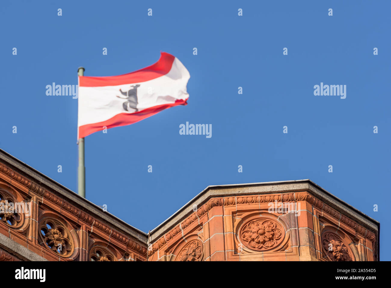 A detail of the Red Town Hall (Rotes Rathaus) of Berlin on which the Berlin flag is flying, Germany Stock Photo