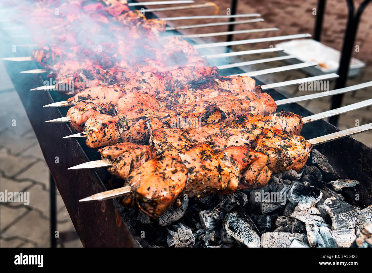 Hot grilled pork kebab or barbecue kebab on charcoal background with