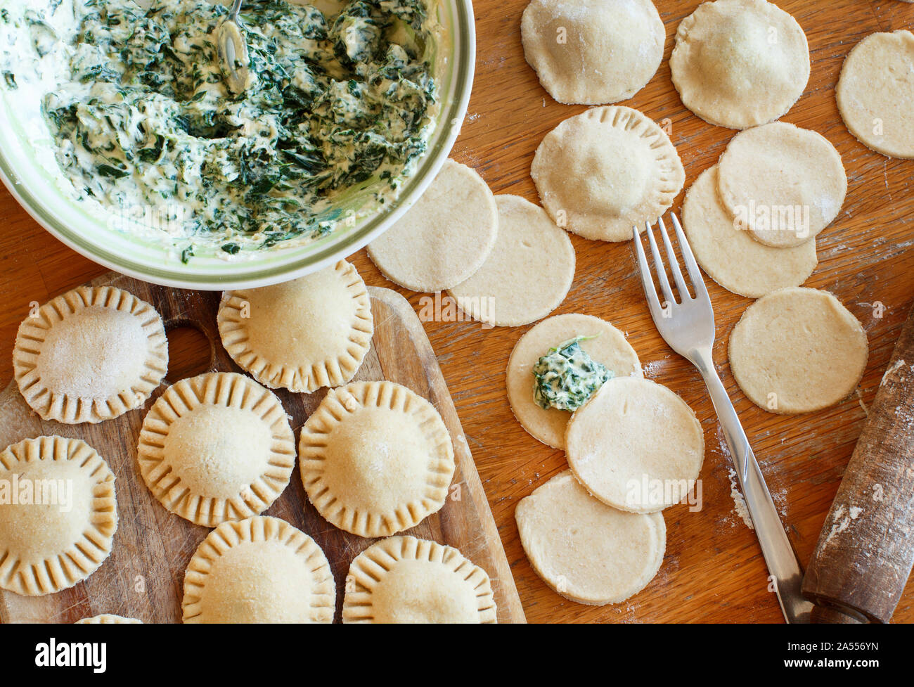 Making ravioli with ricotta cheese and spinach on a wooden board Stock Photo