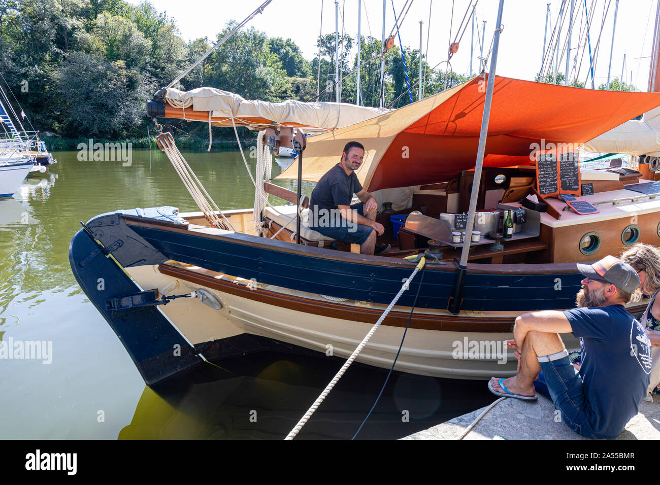La Roche-Bernard, Brittany, France.  Beautifully restored boat now being used to sell Crepes to the tourists Stock Photo