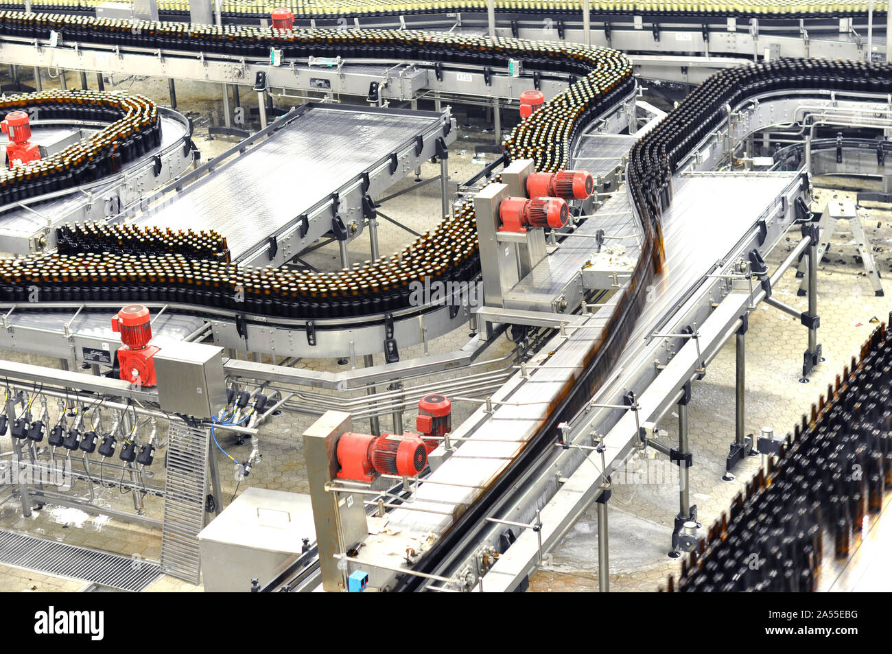 modern factory in the food industry - beer brewery - conveyor belt with beer bottles and machines for production Stock Photo