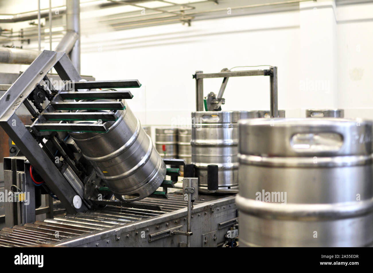 beer barrels in the filling process in a brewery - beer production in the modern food industry Stock Photo