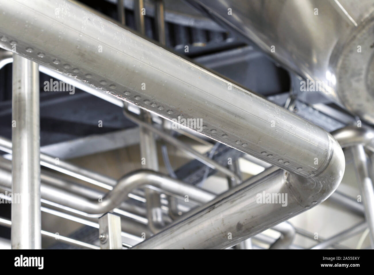 Industrial plant in a modern brewery - technology in a factory building with pipes and fittings Stock Photo