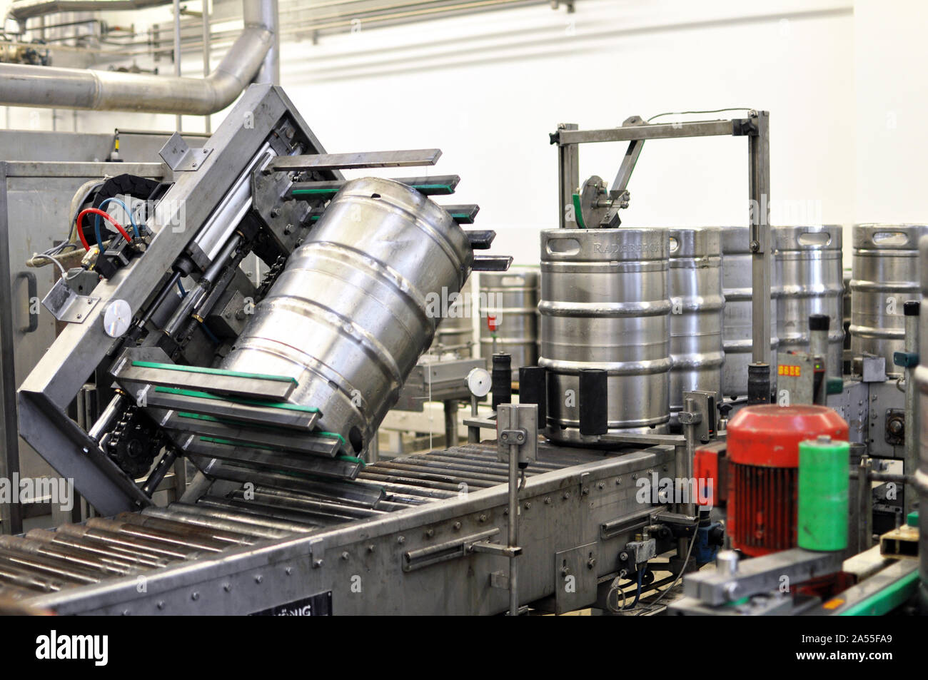 beer barrels in the filling process in a brewery - beer production in the modern food industry Stock Photo