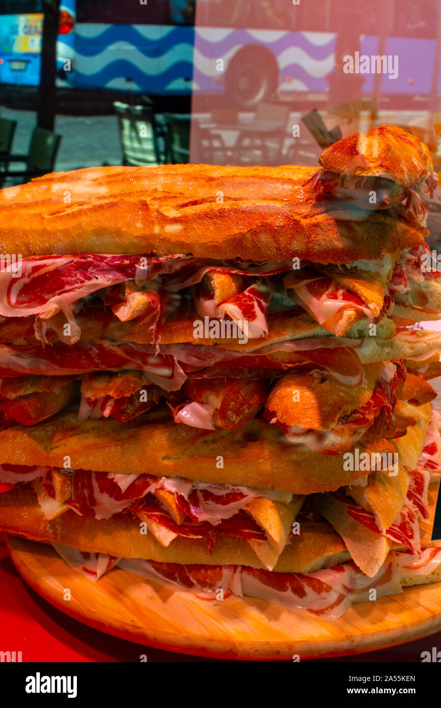 Spanish tapas street food, bocadillo fresh bread with jamon iberico