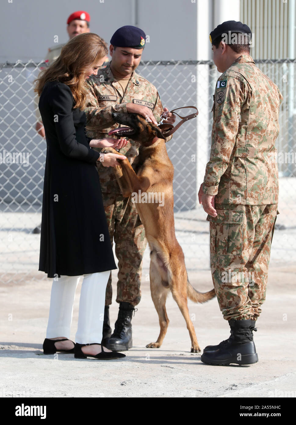 The Duchess of Cambridge, with Captain Aqeel of the Pakistan Army (centre) and Belgian Malinois dog Tutu, during a visit to the Army Canine Centre, where the UK provides support to a programme that trains dogs to identify explosive devices, in Islamabad, on the fifth and final day of the royal visit to Pakistan. Stock Photo