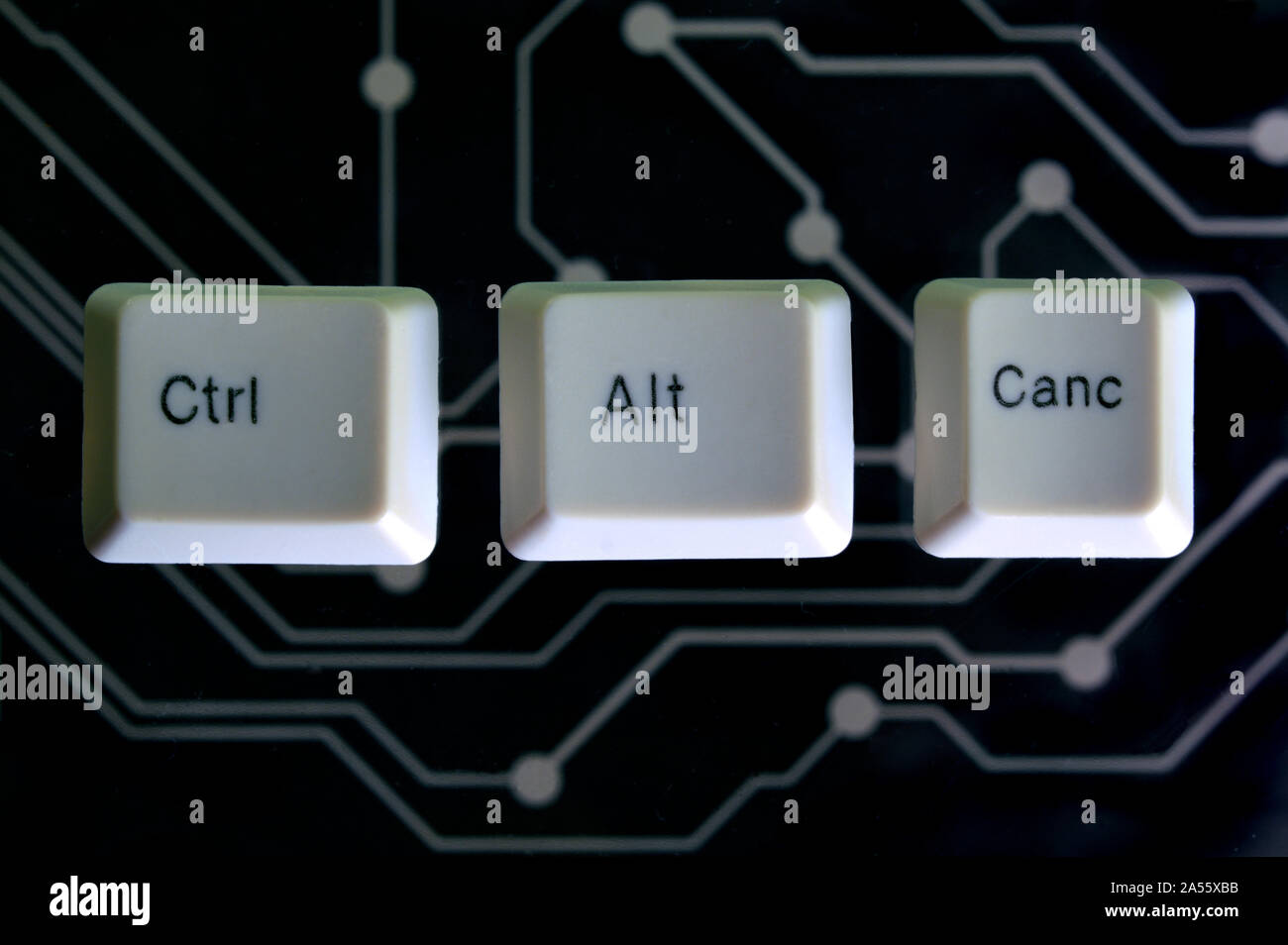 Keyboard keys form the word CTRL ALT CANC on black electric circuit in