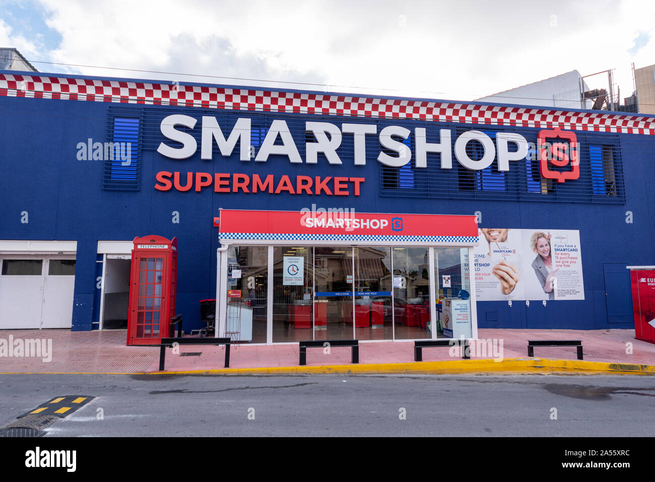 Smartshop Supermarket English, British oriented shop store in Ciudad Quesada, Rojales Spain. Brits abroad. Appealing to ex-pats with red telephone box Stock Photo