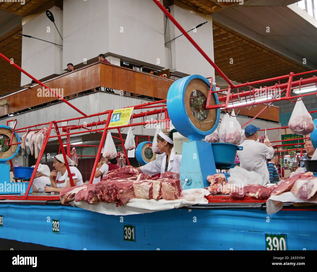 Almaty, Kazakhstan - August 22, 2019: People and goods in the meat section of the famous Green Bazaar of Almaty, Kazakhstan. Stock Photo