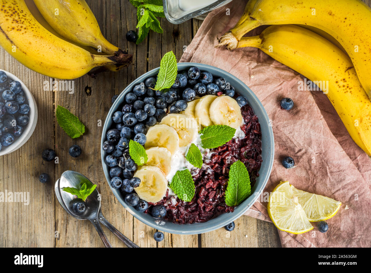 Black rice pudding breakfast bowl with fresh fruits and coconut milk