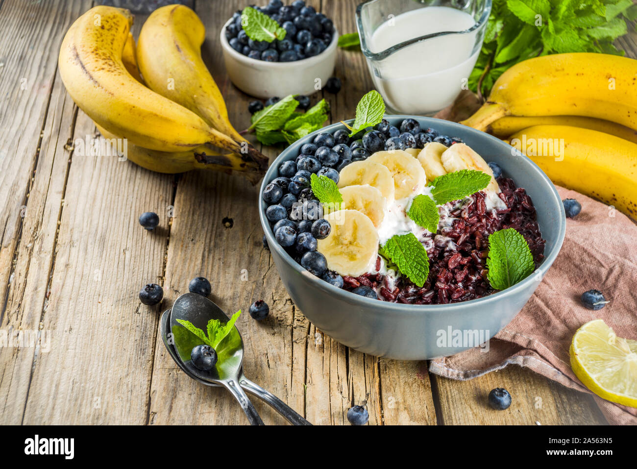 Black rice pudding breakfast bowl with fresh fruits and coconut milk