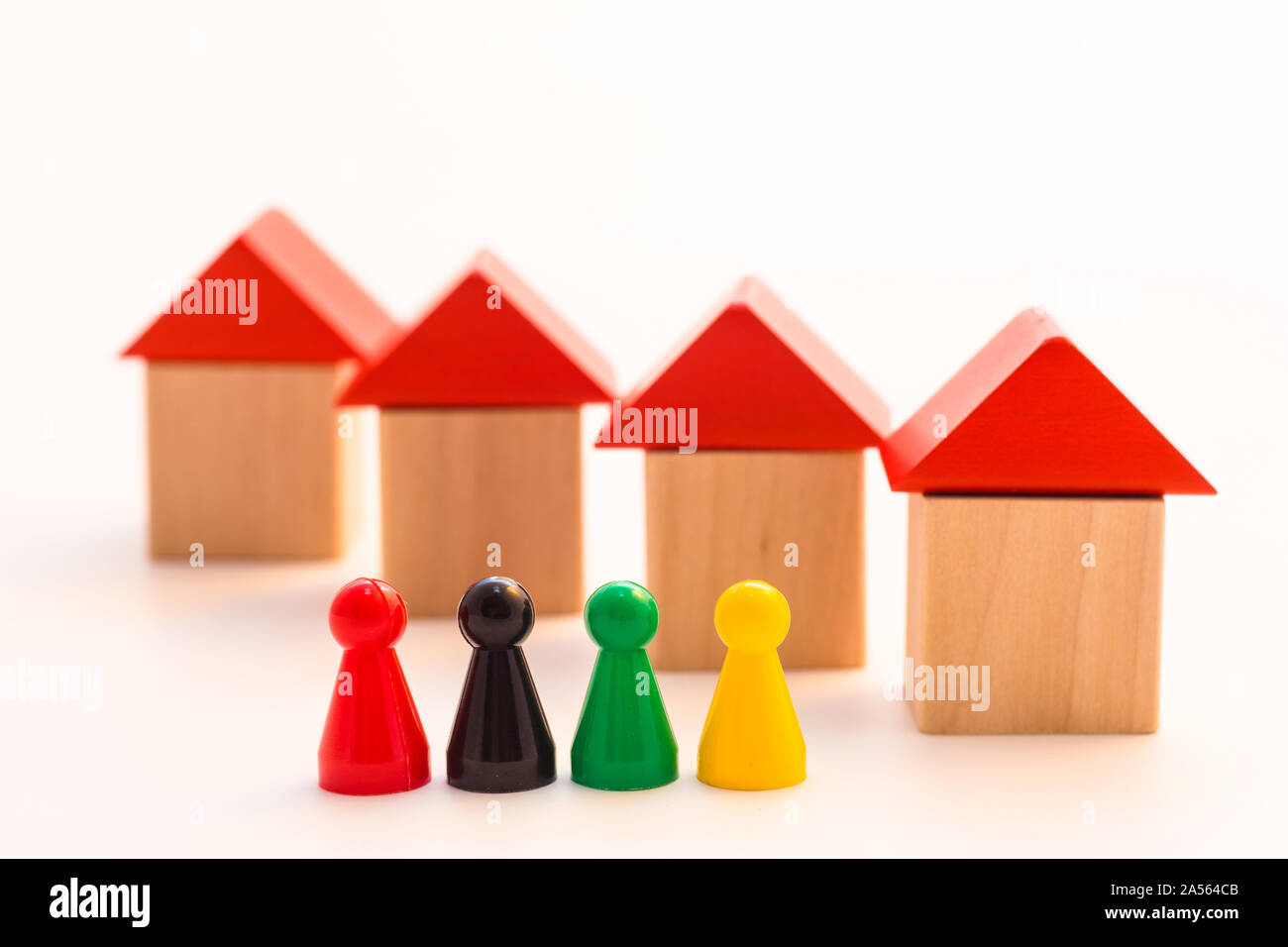 four meeple standing in front of four shifted wooden houses Stock Photo ...
