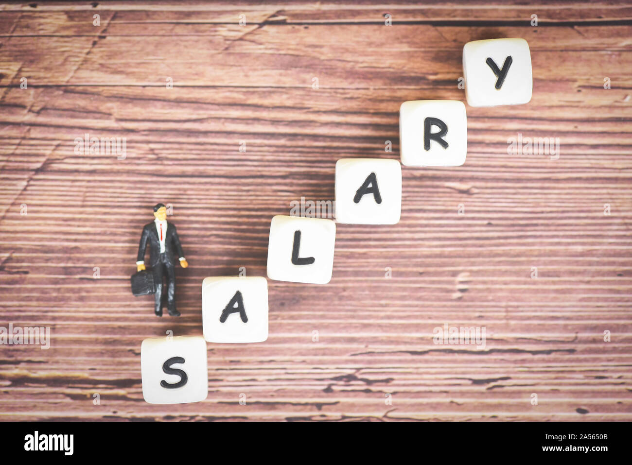 Payroll and salaries ladder increase growth money coins on table and