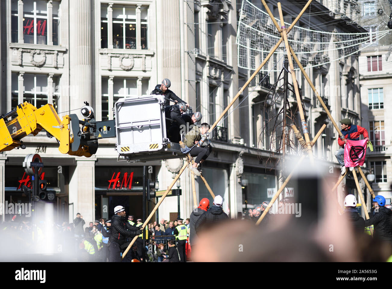 London, UK. 18th Oct, 2019. A climate change protestor is removed from a makeshift structure built in London’s Oxford Circus. Credit: Kevin Shalvey/Alamy Live News Stock Photo