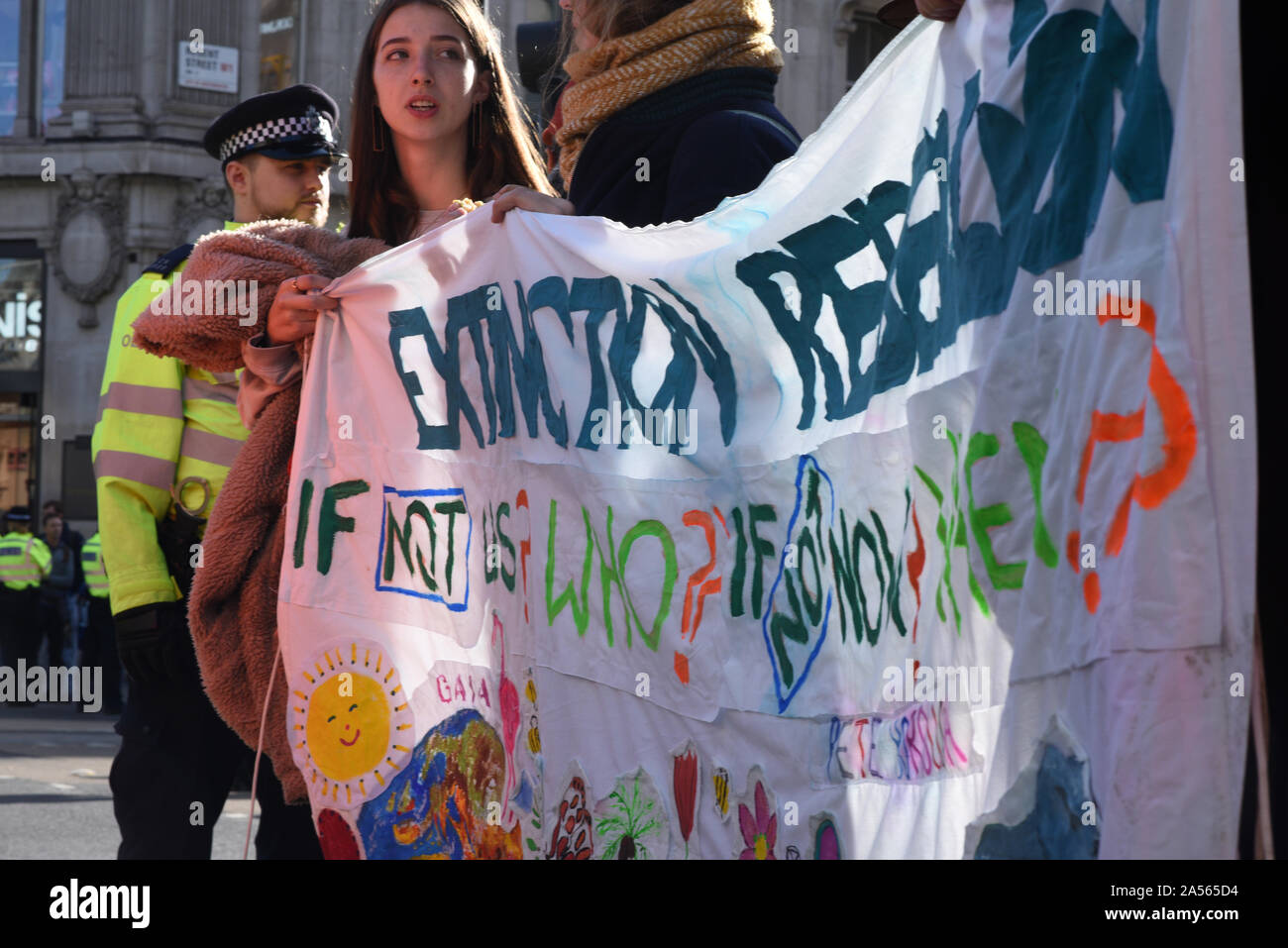 London, UK. 18th Oct, 2019. Young protestors hold an Extinction Rebellion sign as climate change activits occupy London’s Oxford Circus. Credit: Kevin Shalvey/Alamy Live News Stock Photo