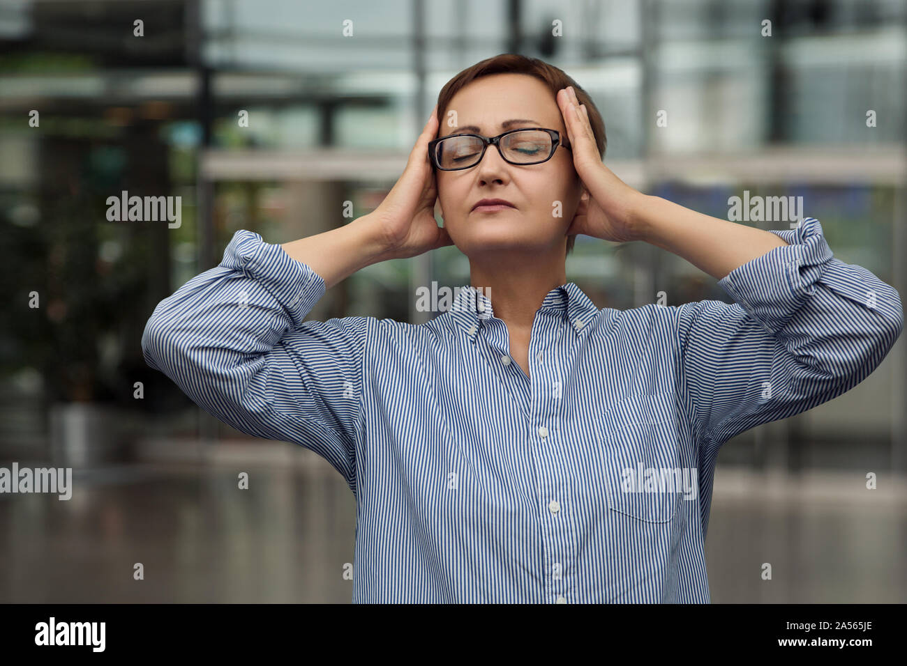 Stressed woman at the office Stock Photo