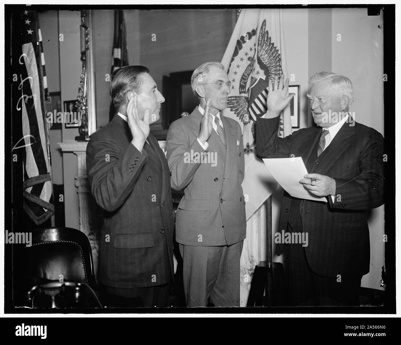 Vice President Garner administers oath to new Florida Senators. Washington, D.C., Dec. 8. Florida's new senators, Claude Pepper and Charles O. Andrews, presented their credentials and were administered the oath of office today by Vice President John N. Garner. Left to right: Senator Pepper, Senator Andrews, and Vice President Garner Stock Photo