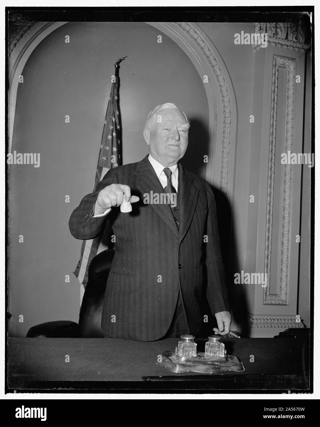 Vice President ready for opening. Washington, D.C., Dec. 29. A sure sign that Congress is ready to convene on January 3. Vice President Garner posing, gavel in hand, on the rostrum in the Senate chamber, 12/29/38 Stock Photo