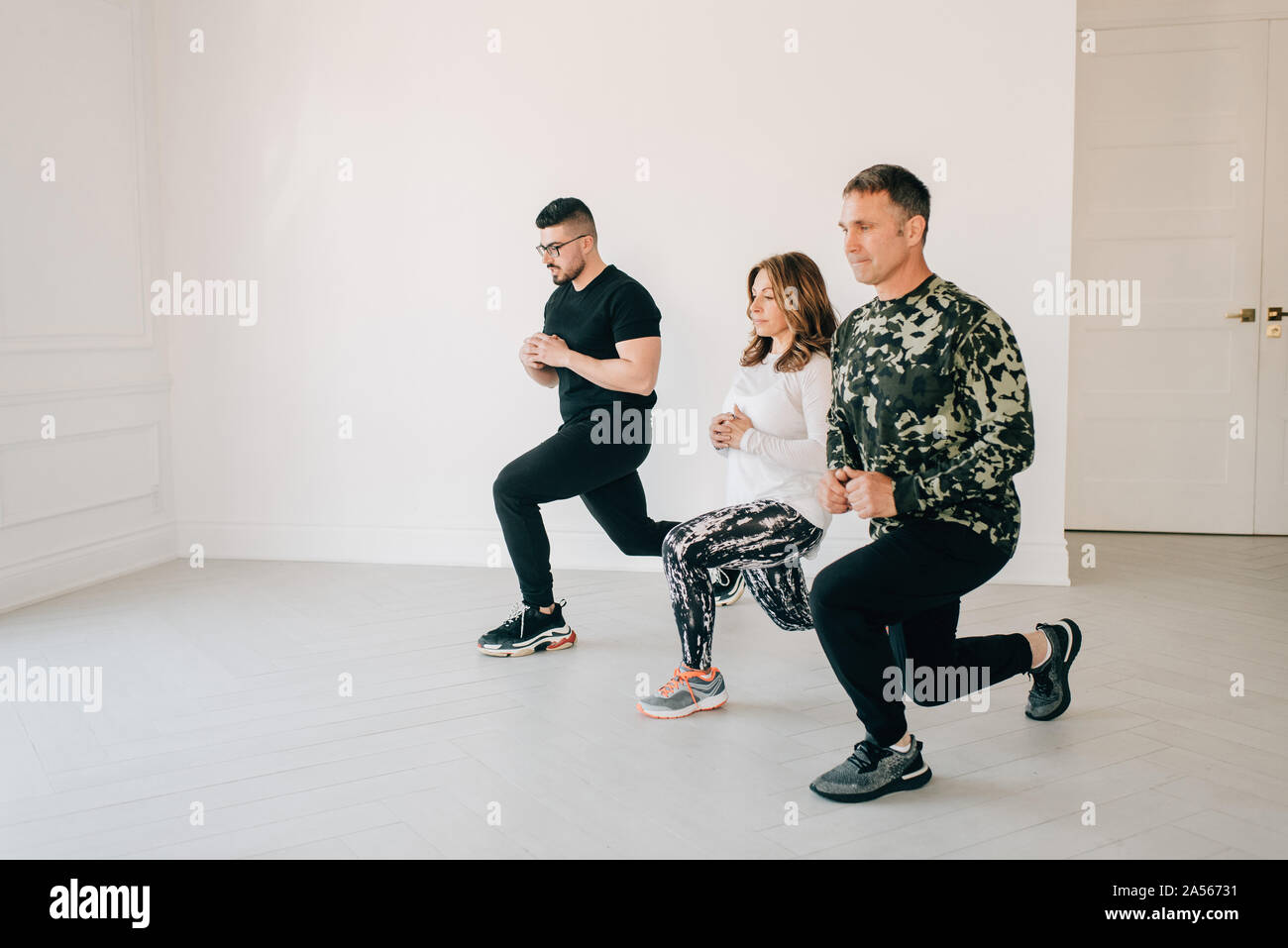 Friends doing lunges in studio Stock Photo