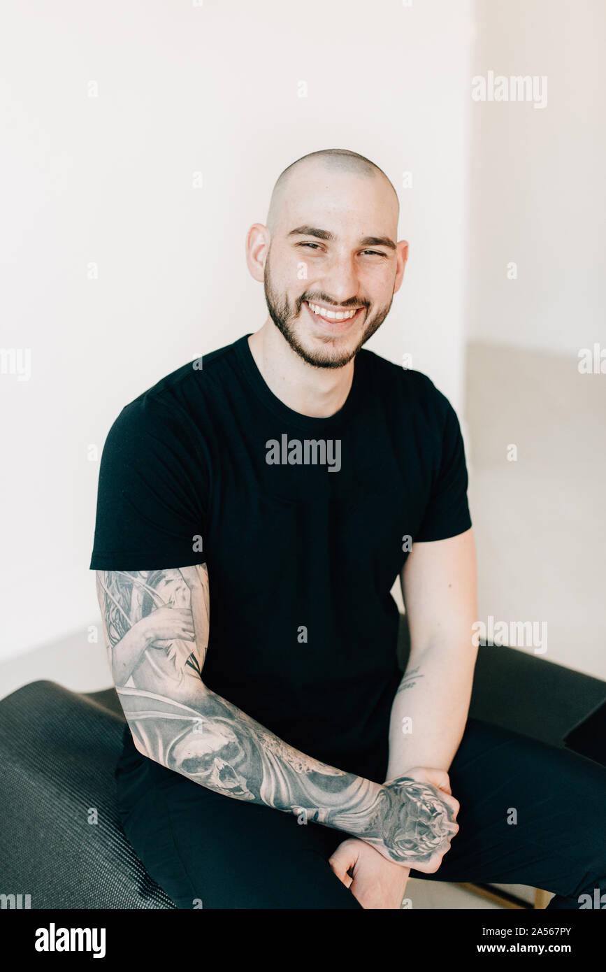 Portrait of young man with tattoo in studio Stock Photo
