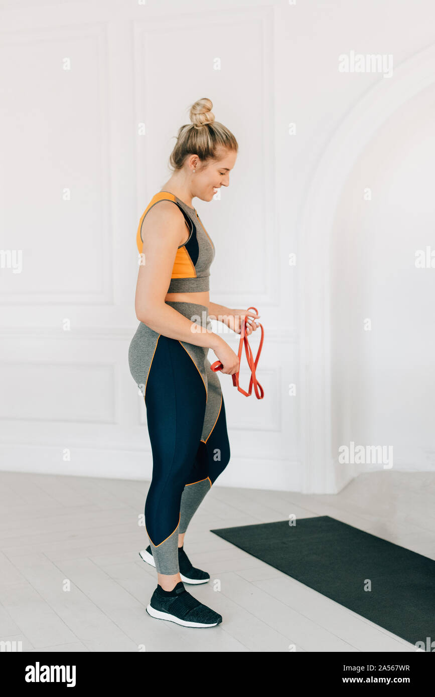 Woman with resistance band in studio Stock Photo
