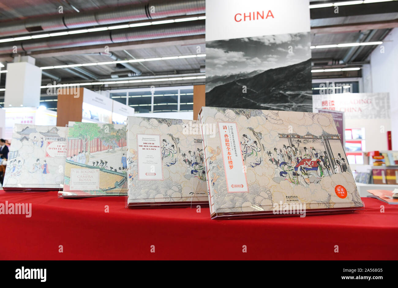 (191018) -- FRANKFURT, Oct. 18, 2019 (Xinhua) -- Photo taken on Oct. 17, 2019 shows limited editions in Chinese, English, Italian and French (R to L) of 'Illustrated Classics of Chinese Literature: Dream of the Red Chamber by Sun Wen' at Frankfurt Book Fair in Frankfurt, Germany. Modern prints of an ancient illustrated version of the Chinese literary classic 'Dream of the Red Chamber' were launched globally Thursday at the annual Frankfurt Book Fair in multilingual limited editions.   'Dream of the Red Chamber,' written by Cao Xueqin in the mid-18th century during the Qing Dynasty, is one of t Stock Photo