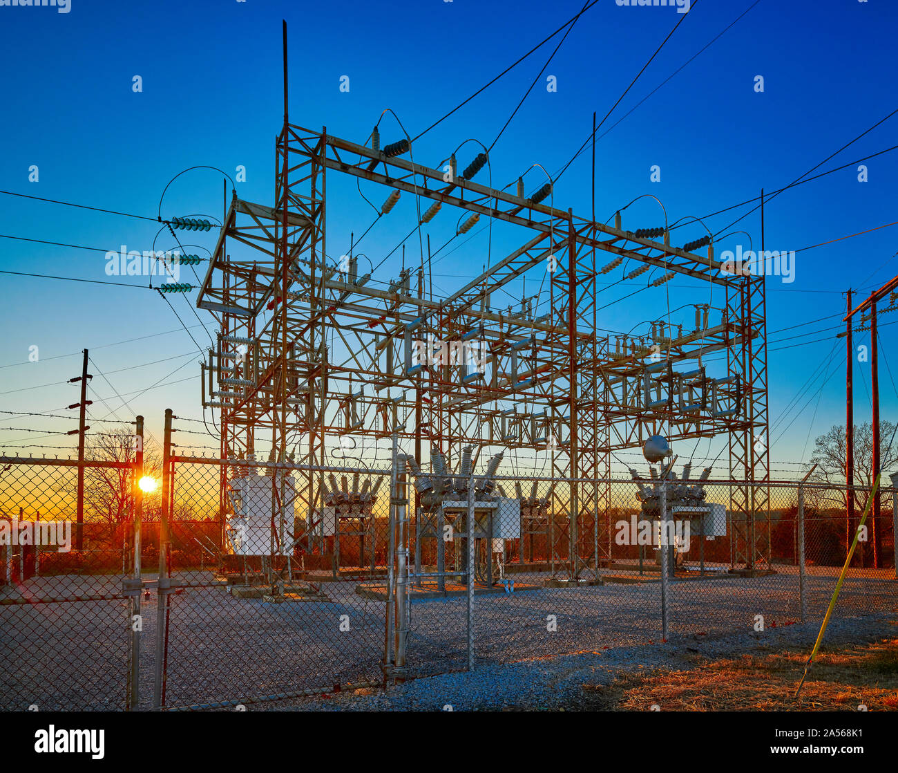 Electric substation at sunset with blue sky. Stock Photo