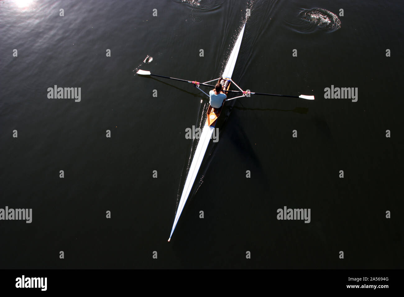 Aerial view of a rower rowing a single skull in Oxford on the Thames