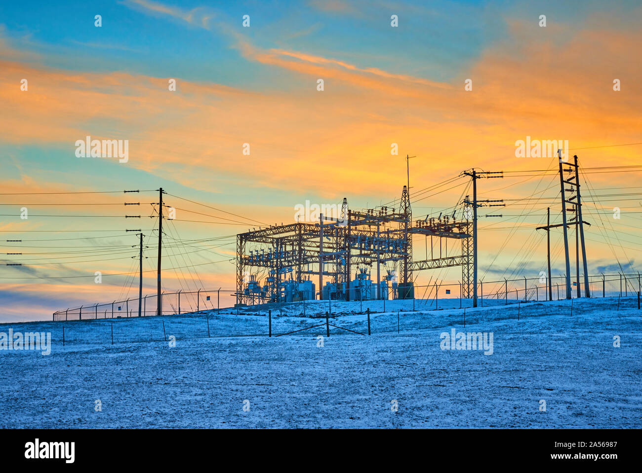 Electric substation at sunset with blue sky and clouds. Stock Photo