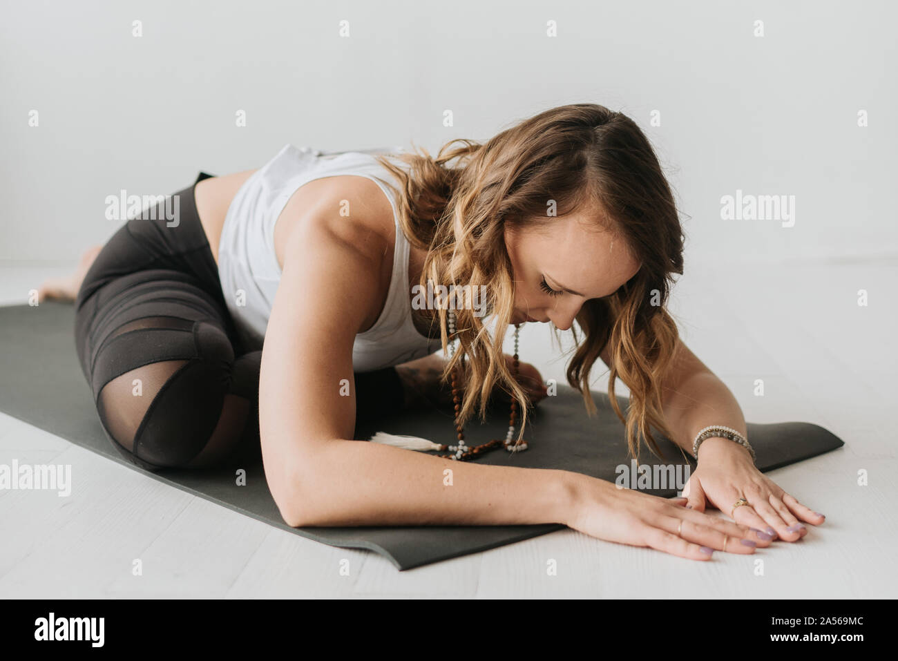 Woman practising yoga in studio Stock Photo
