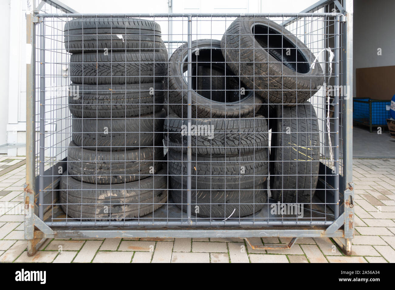 Many old tyres pile up in front of a garage to be disposed of Stock