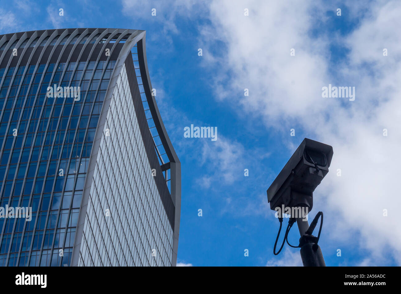 Security CCTV camera with skyscrapers in background. Security CCTV ...