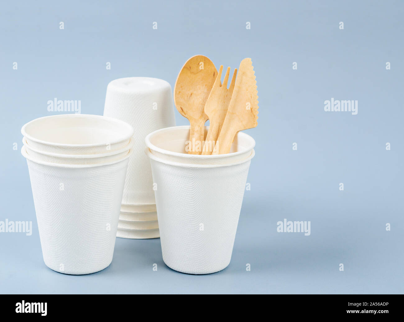 Water glass made from plant fiber and disposable spoon. Natural fiber eco food and drink packaging concept. Stock Photo