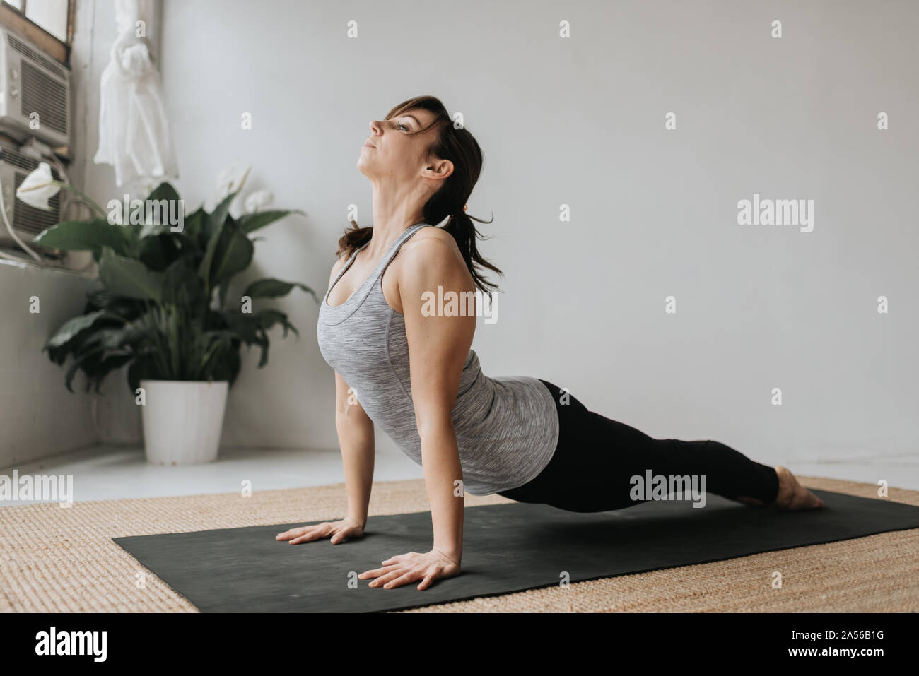 Woman practising yoga in studio Stock Photo