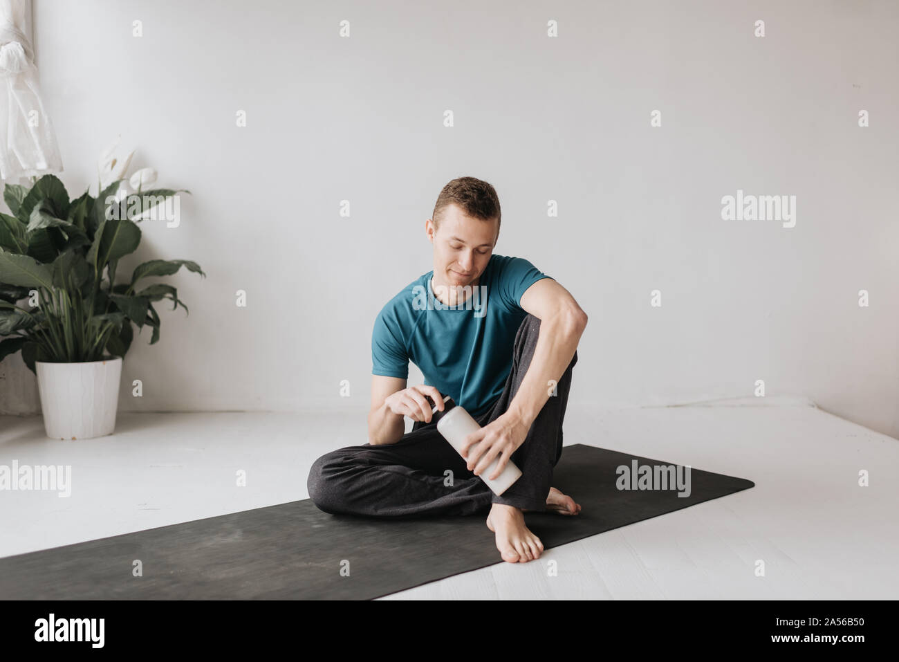 Man taking break in yoga studio Stock Photo