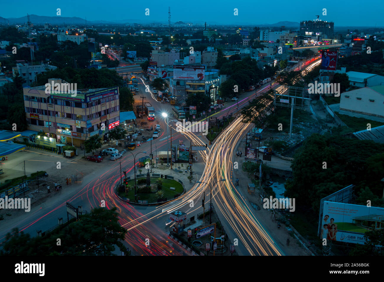 head and tail light trails at blue hour forming an L and an X at a traffic circle in India - Vellore September 2019 Stock Photo