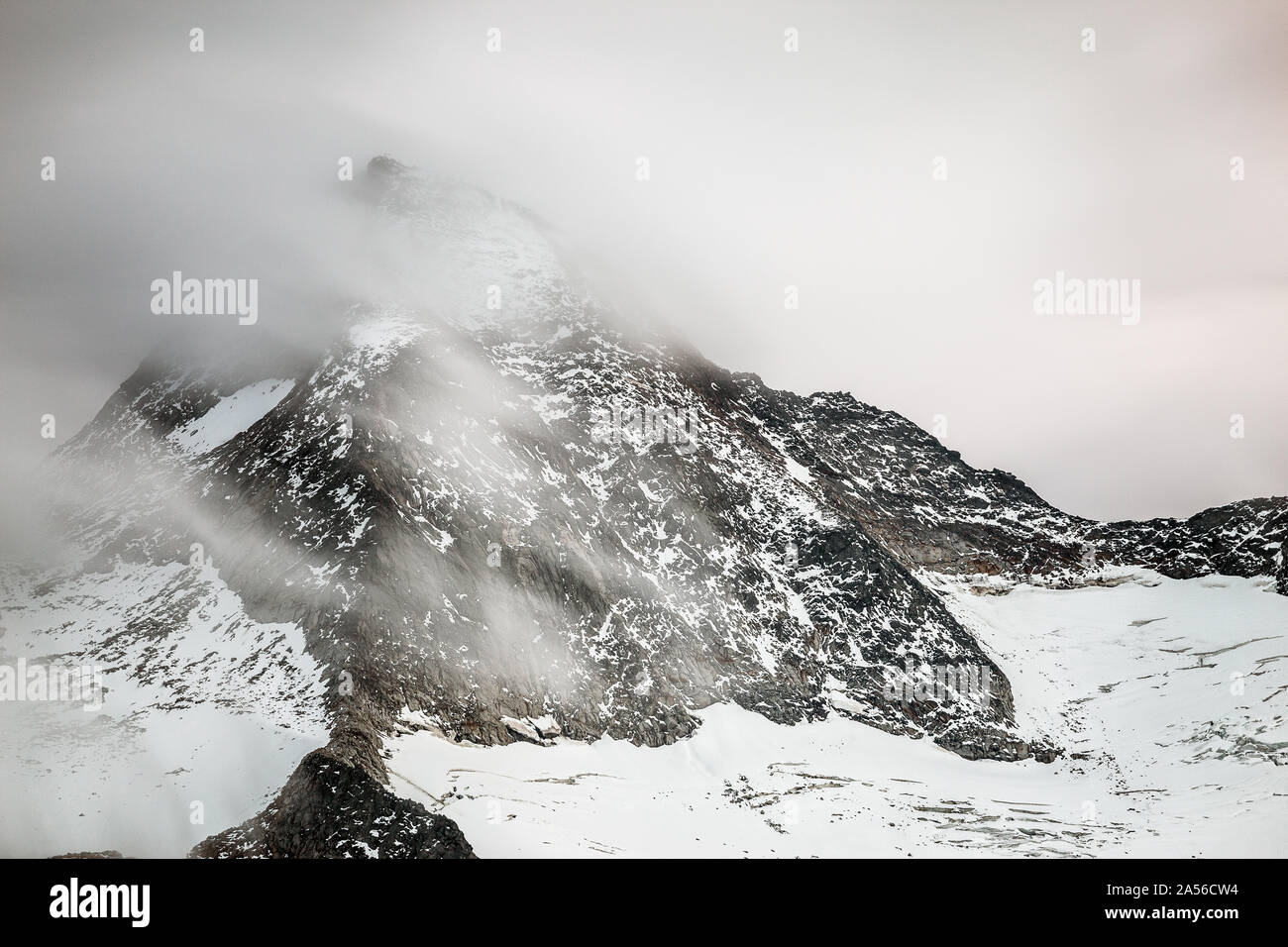 Großer Geiger mountain peak (Obersulzbacher Venediger) with moving clouds. Venediger Group. Hohe Tauern National Park. Austrian Alps. Stock Photo