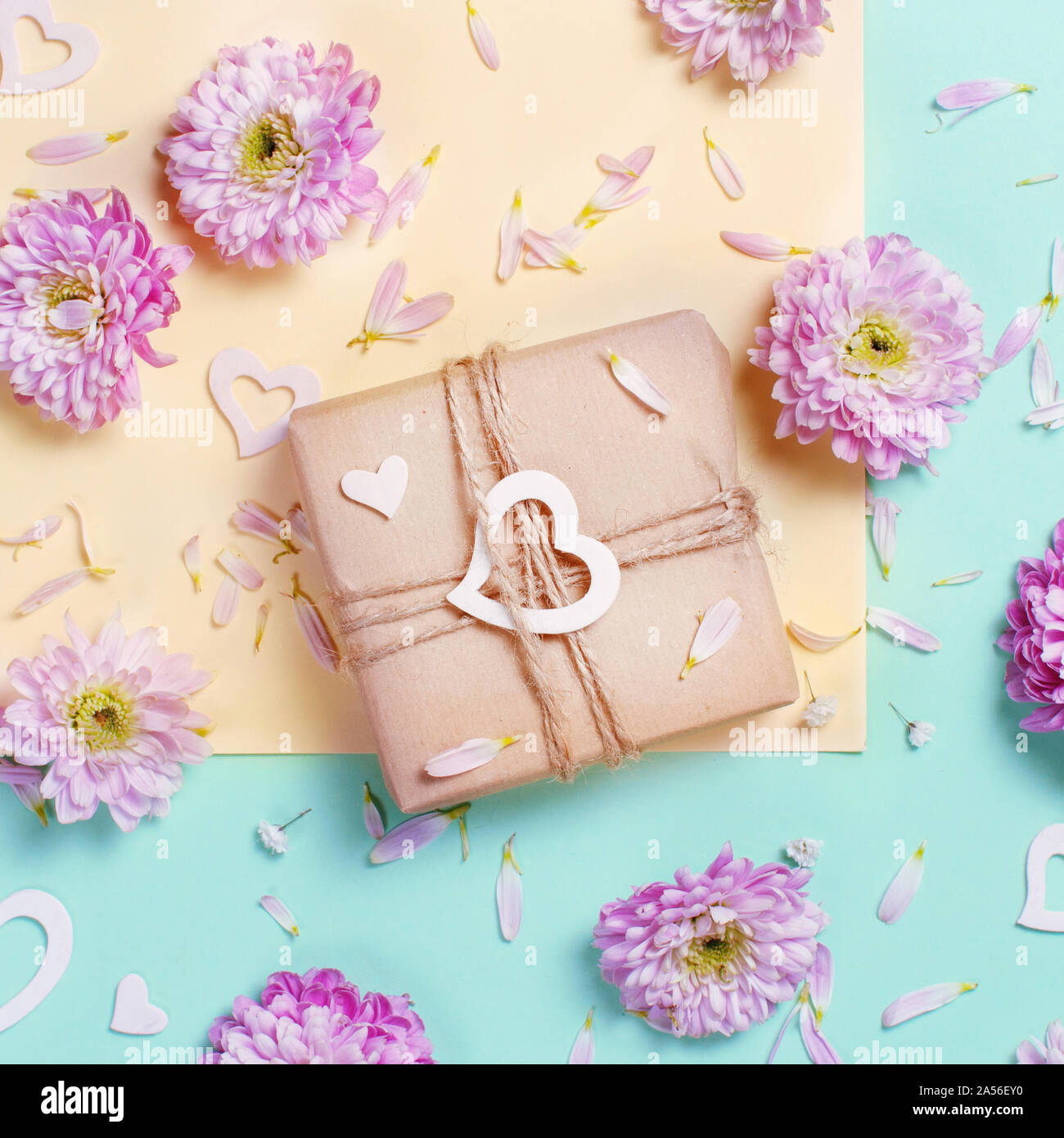 Flowers composition with hearts and gift box on a pastel pink ...