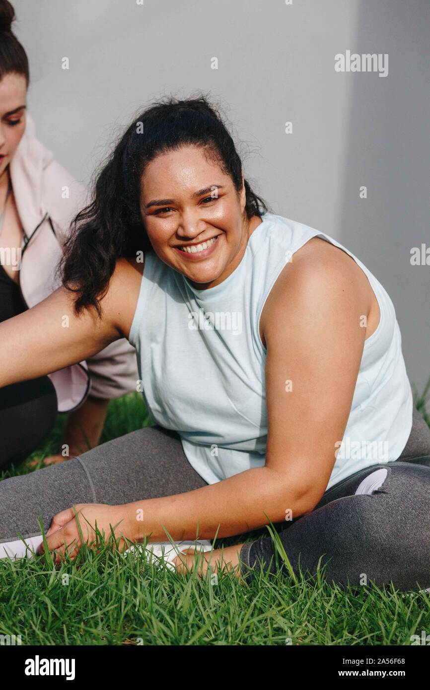 Woman doing stretching exercise in garden Stock Photo