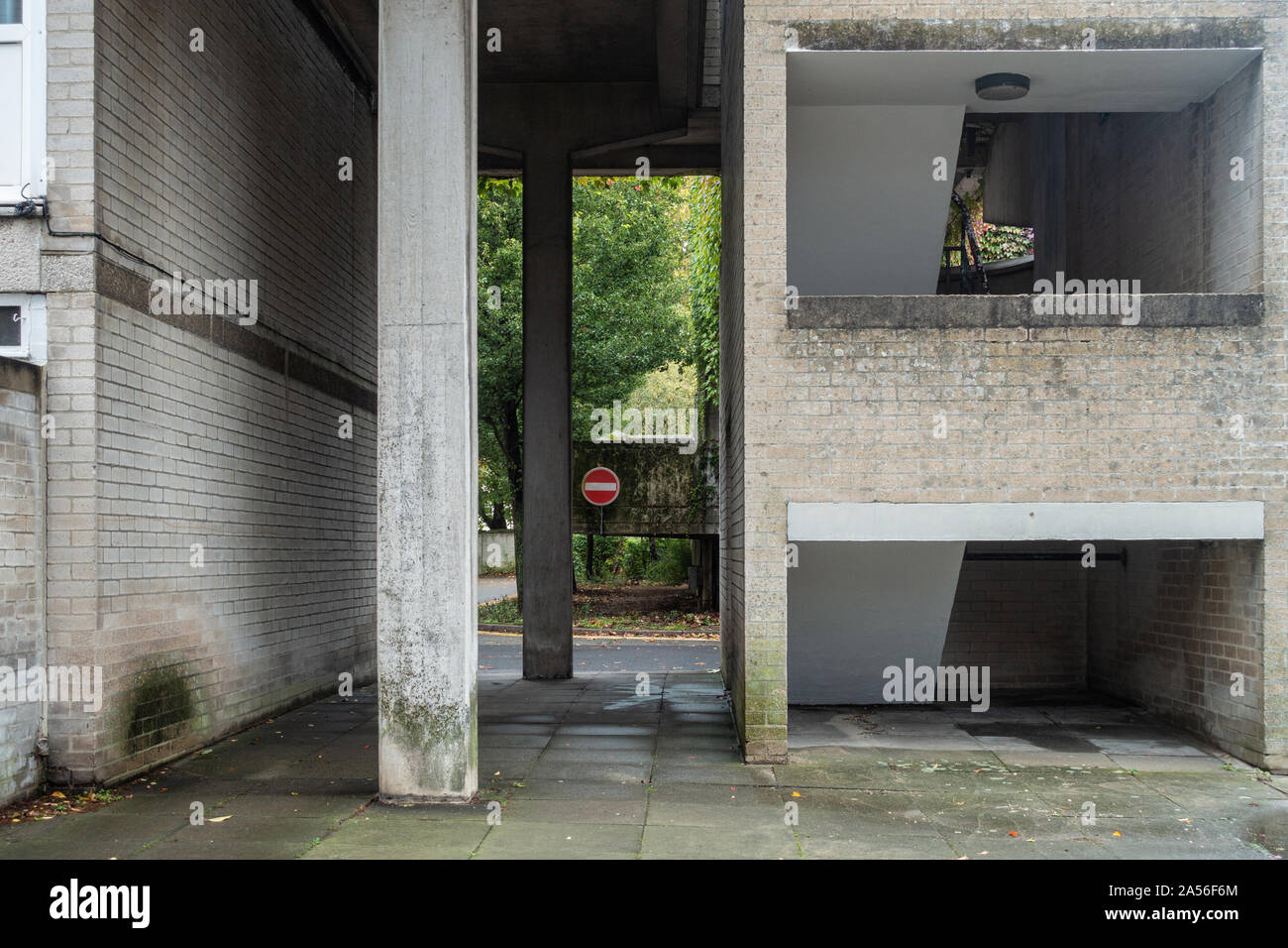A Passageway Between Brick Walls With Concrete Columns Supporting