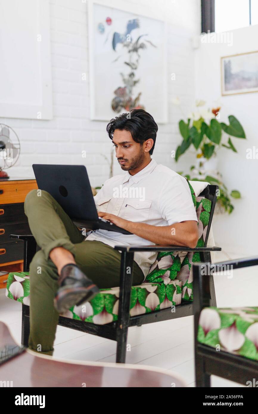 Businessman using laptop in office Stock Photo