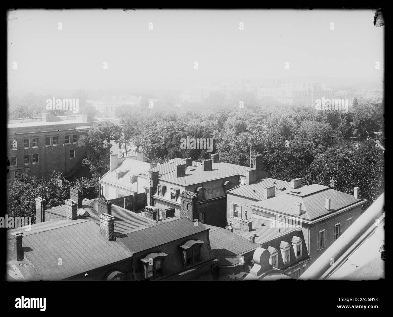 View of Madison Place, N.W., at H Street, looking Southwest from Old Shoreham (15th & H) with a view of the Lafayette Opera House on the left and the White House and Executive Office building in the distance partially obstructed by trees Stock Photo