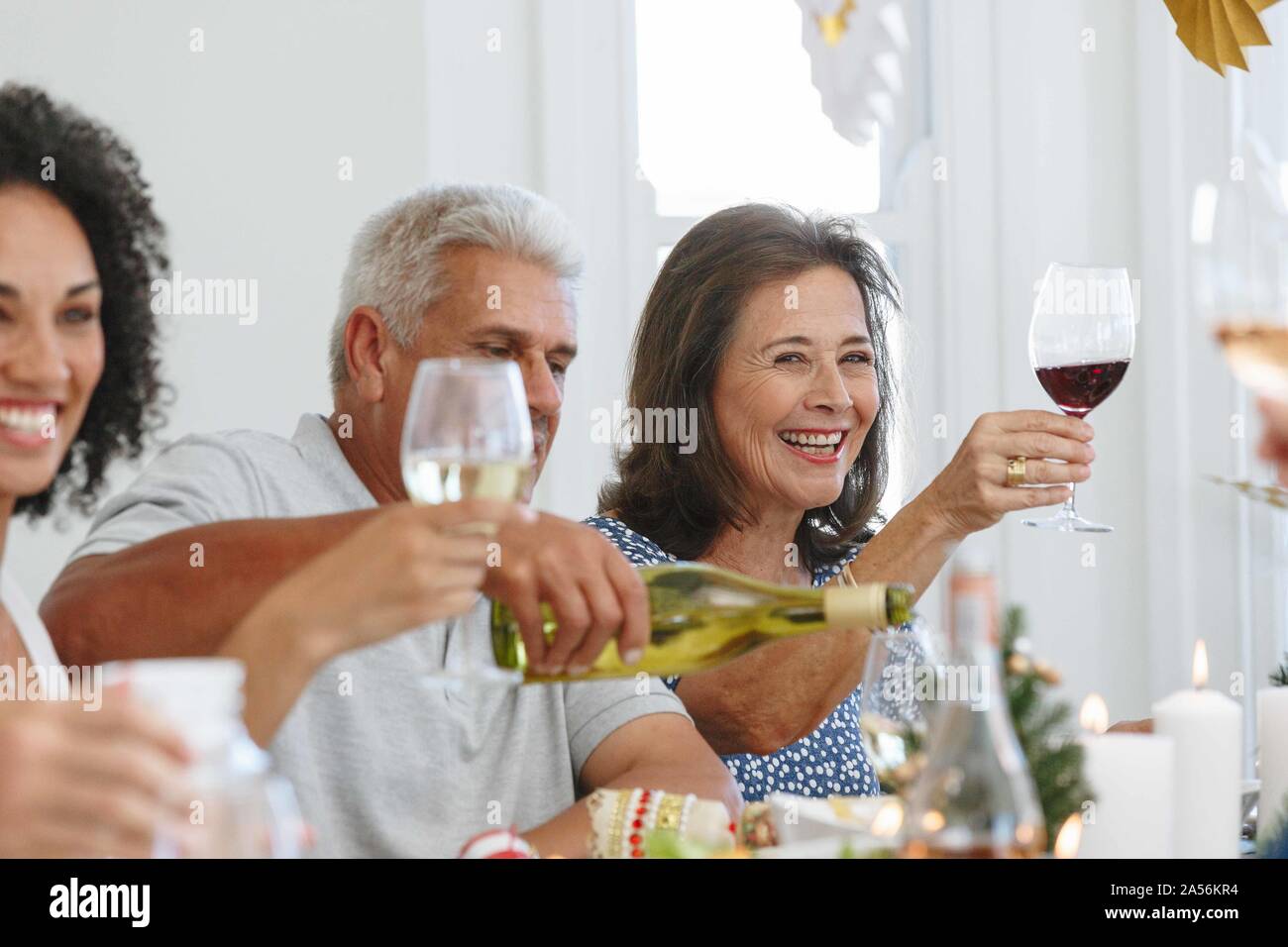 Family toasting wine at home party Stock Photo