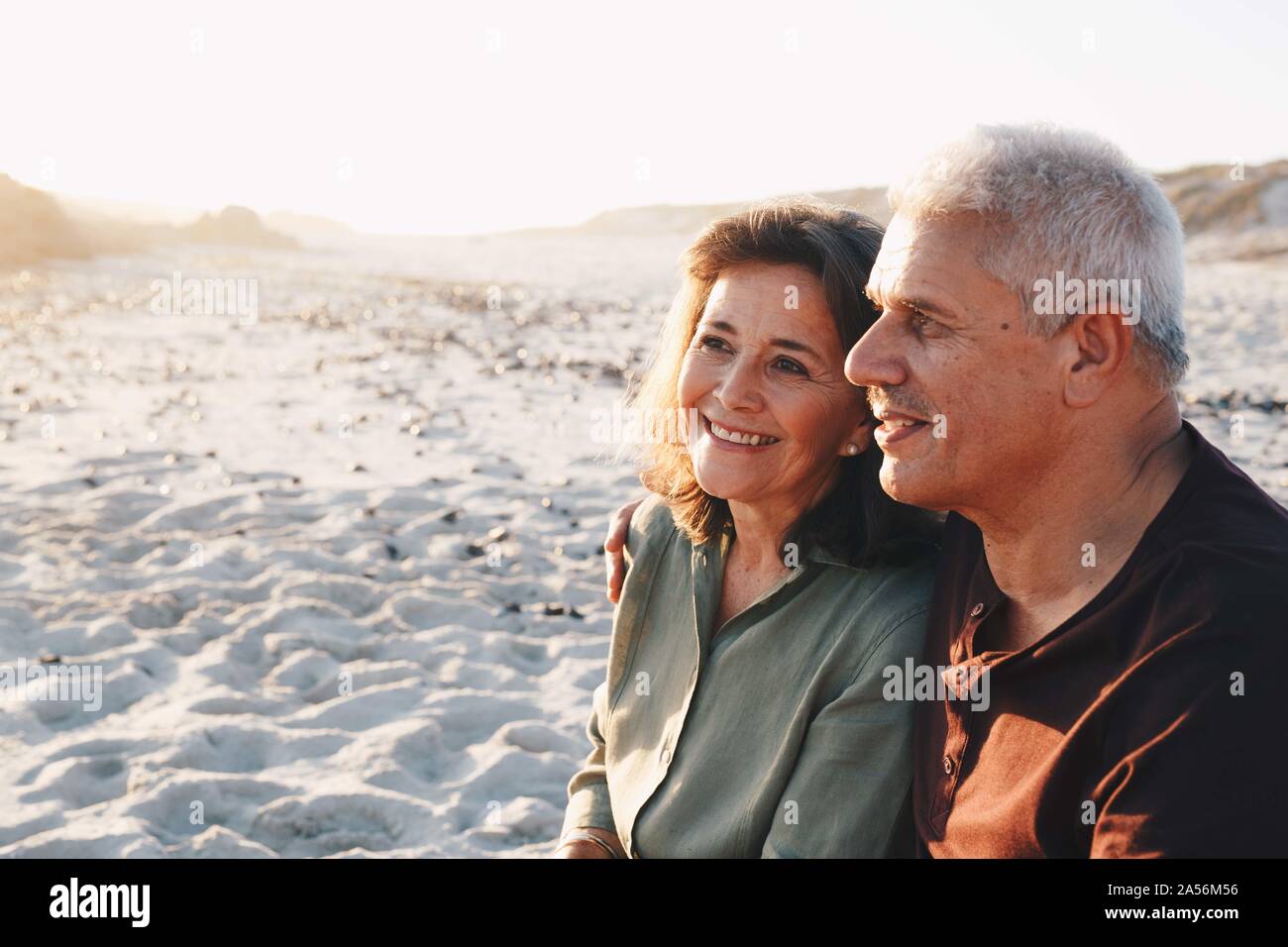 Senior couple enjoying sun on sandy beach Stock Photo
