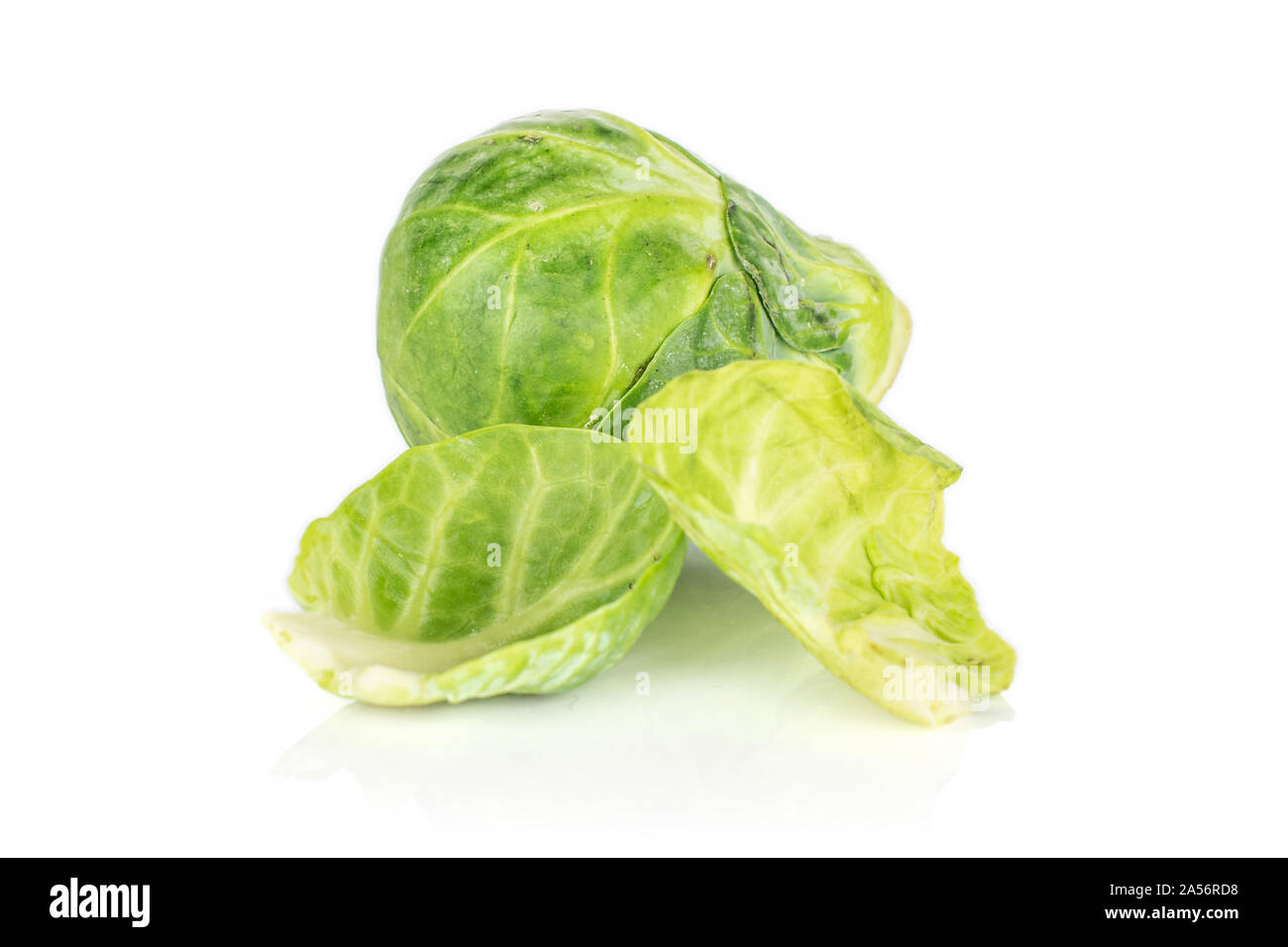 Group of one whole two pieces of fresh green brussels sprout isolated on white background Stock Photo