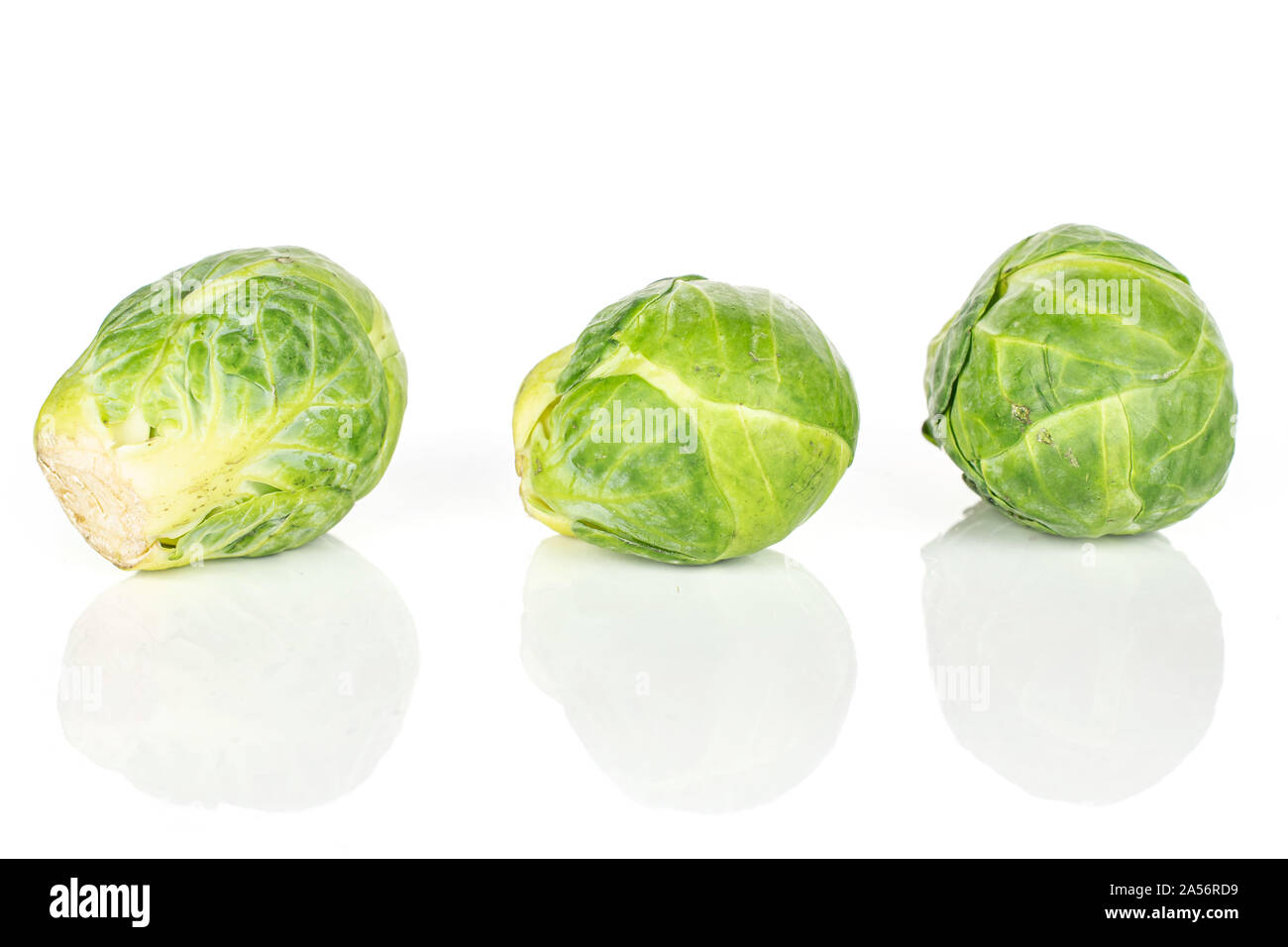 Group of three whole fresh green brussels sprout isolated on white ...