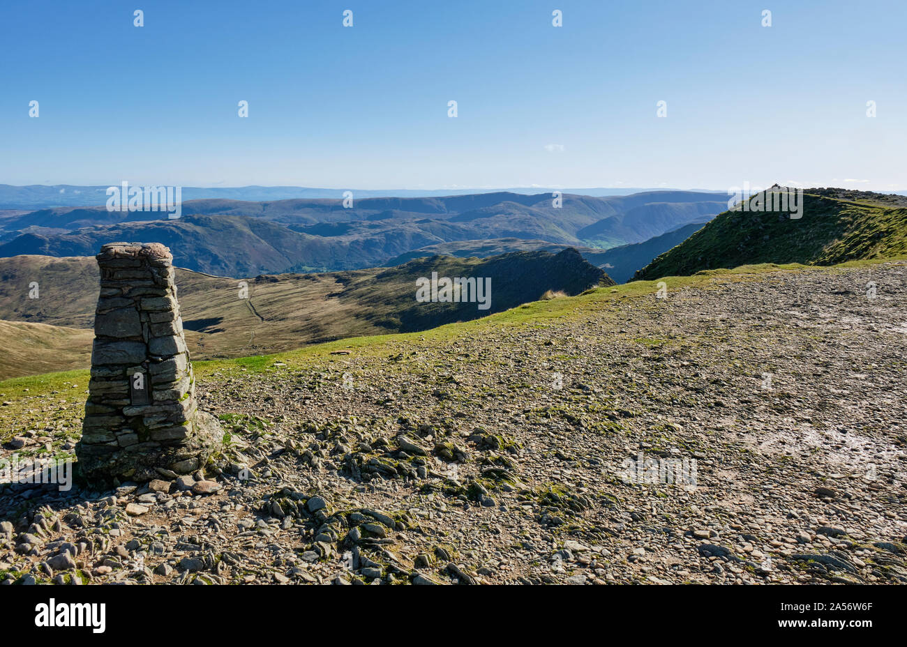 Summit cairn on Helvellyn, with Helvellyn summit and Striding Edge, Helvellyn, Lake District, Cumbria Stock Photo